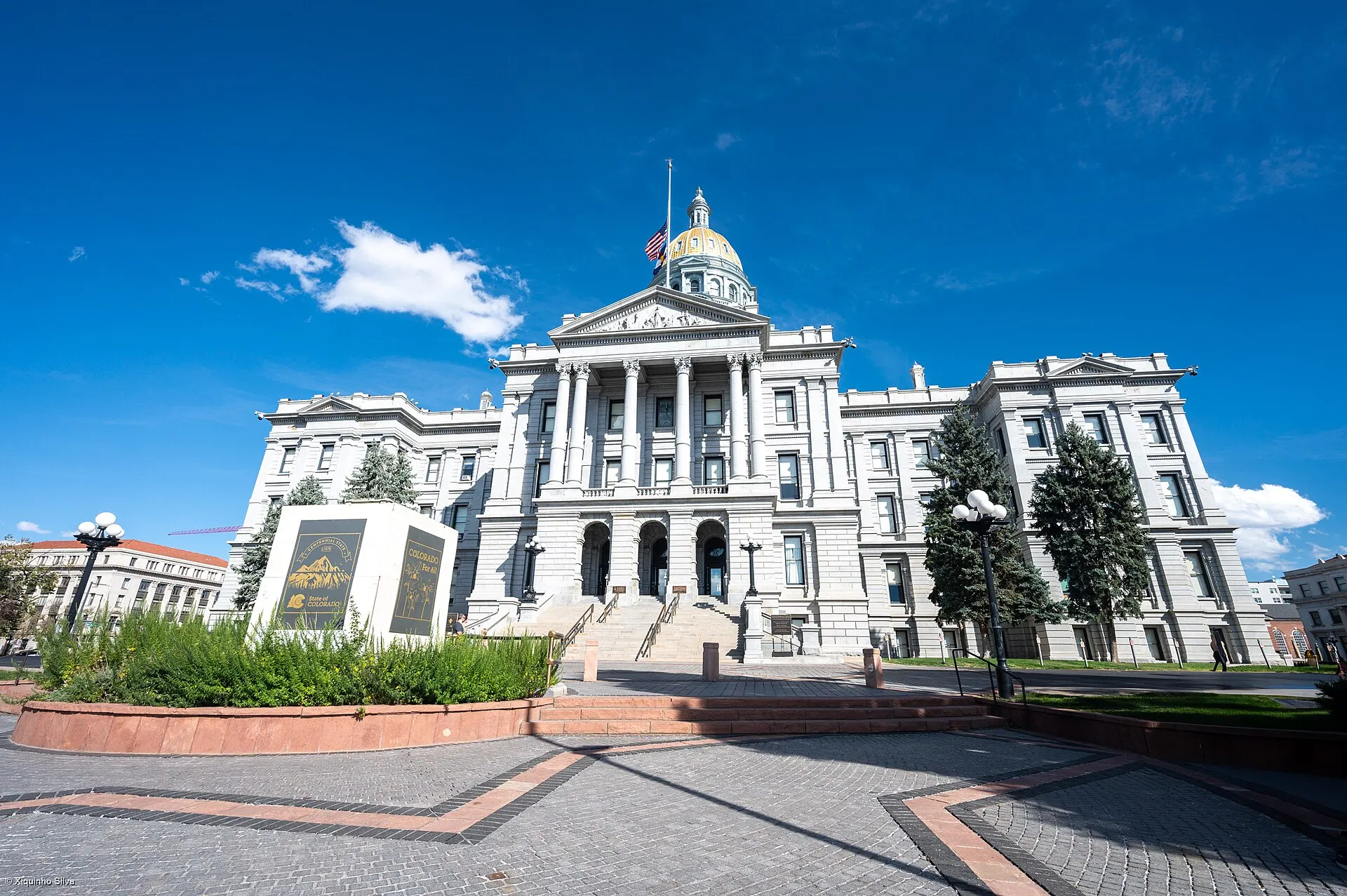The Colorado State Capitol building in Denver, with its gold dome, under a blue sky
